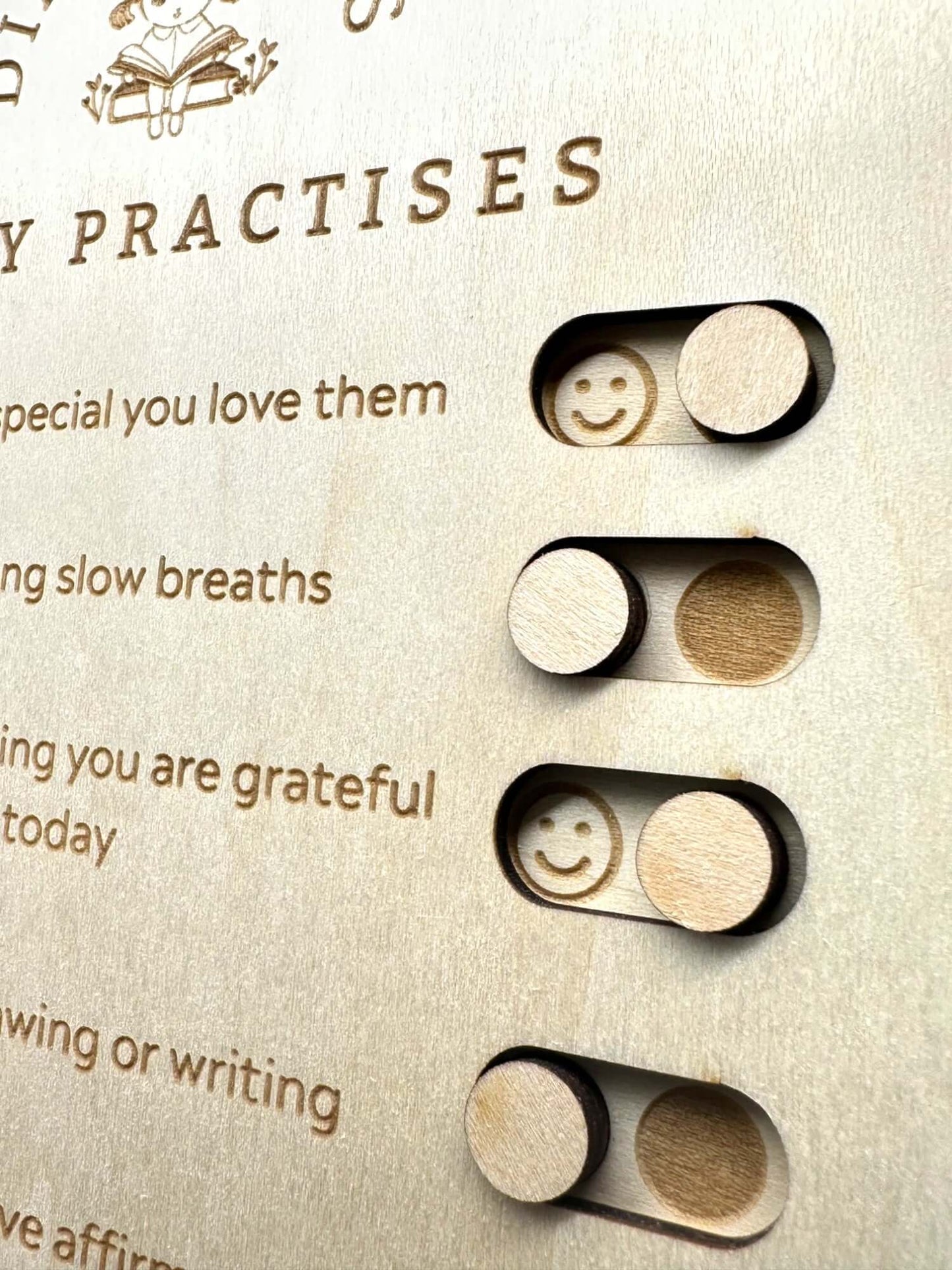 Wooden board with smiley face sliders for daily gratitude practices and mindfulness activities.