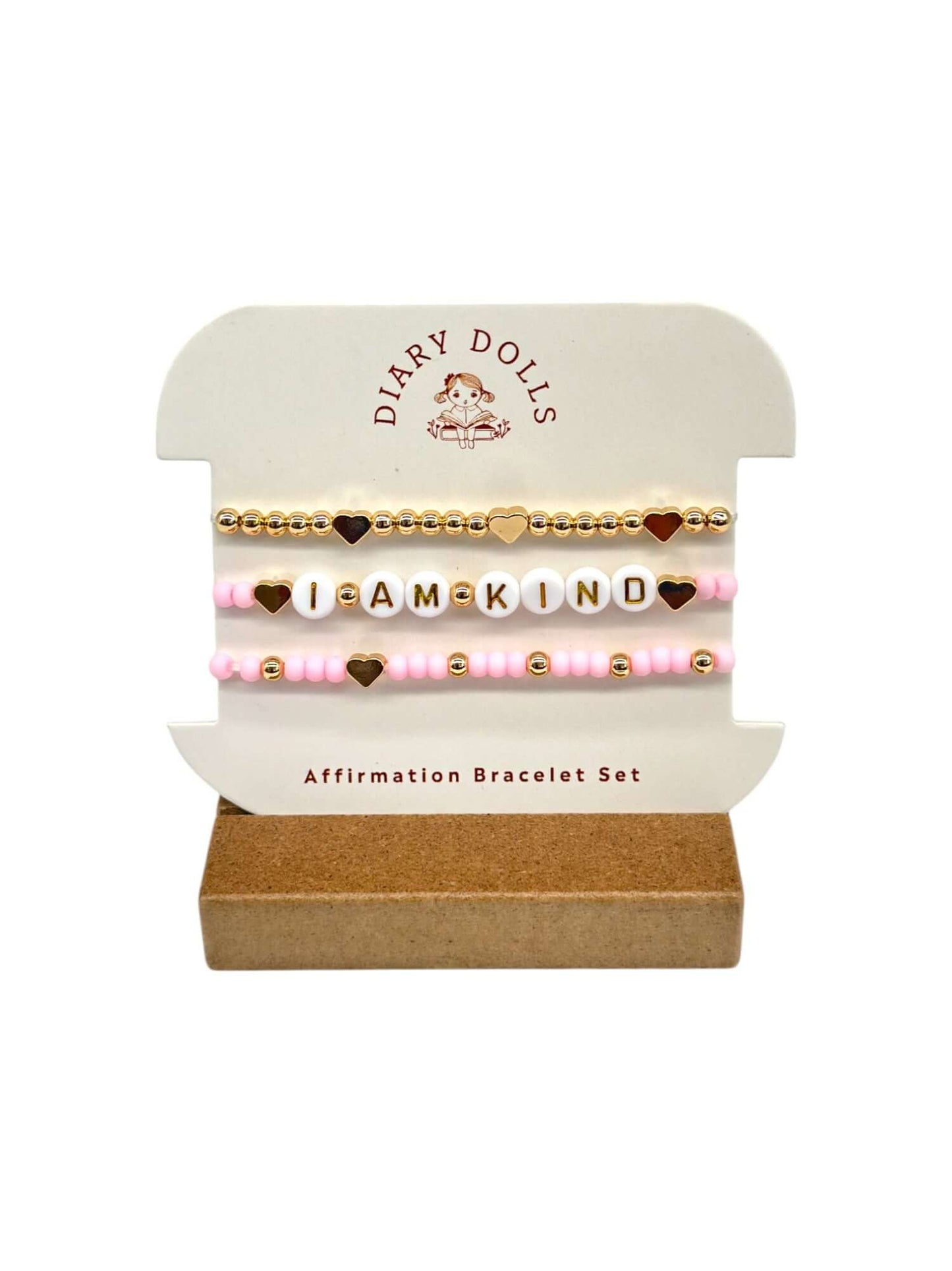 The Daily Affirmation Bundle featuring a plush doll, affirmation book, and motivational bracelets for children's self-confidence.
