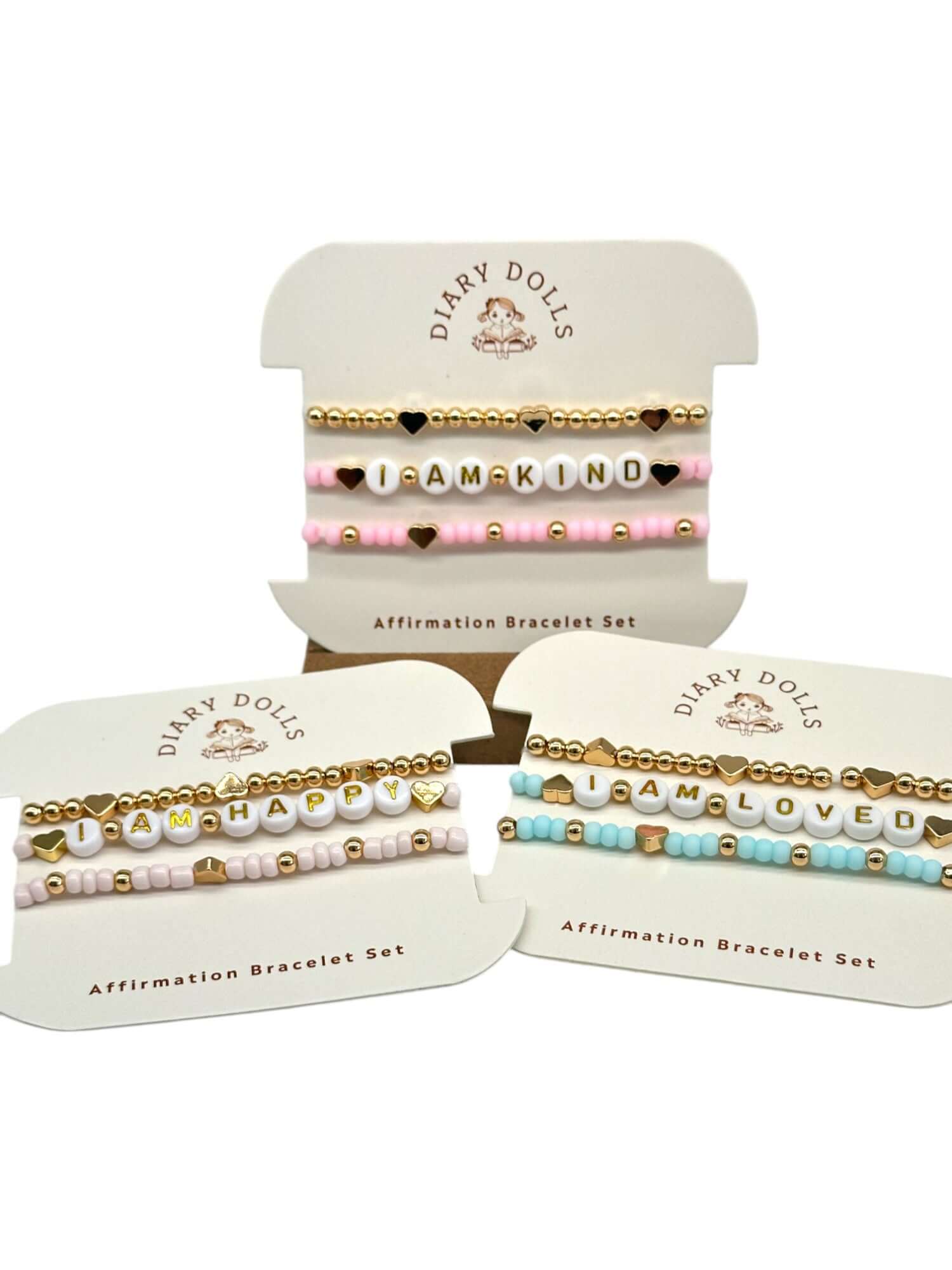 Affirmation bracelet set from Diary Dolls featuring uplifting phrases 'I AM KIND', 'I AM HAPPY', 'I AM LOVED' in colorful beads.