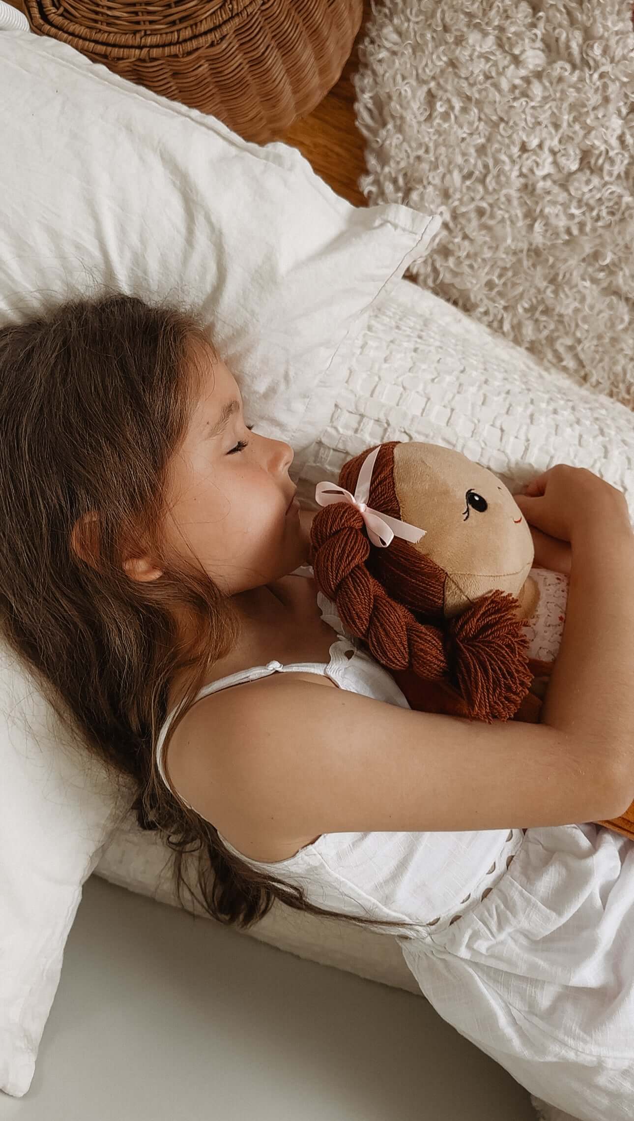 Girl peacefully sleeping with her doll, promoting self-worth and emotional expression through journaling.
